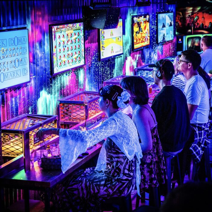 People playing on the free-to-play retro consoles at NQ64 Arcade Bar bartender